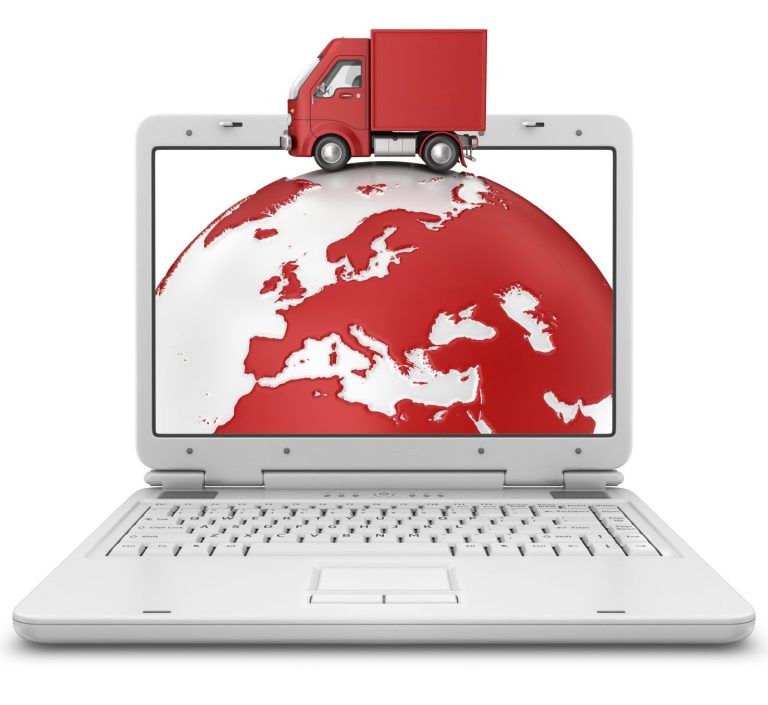 Camion rosso su un computer portatile sopra un globo terrestre.